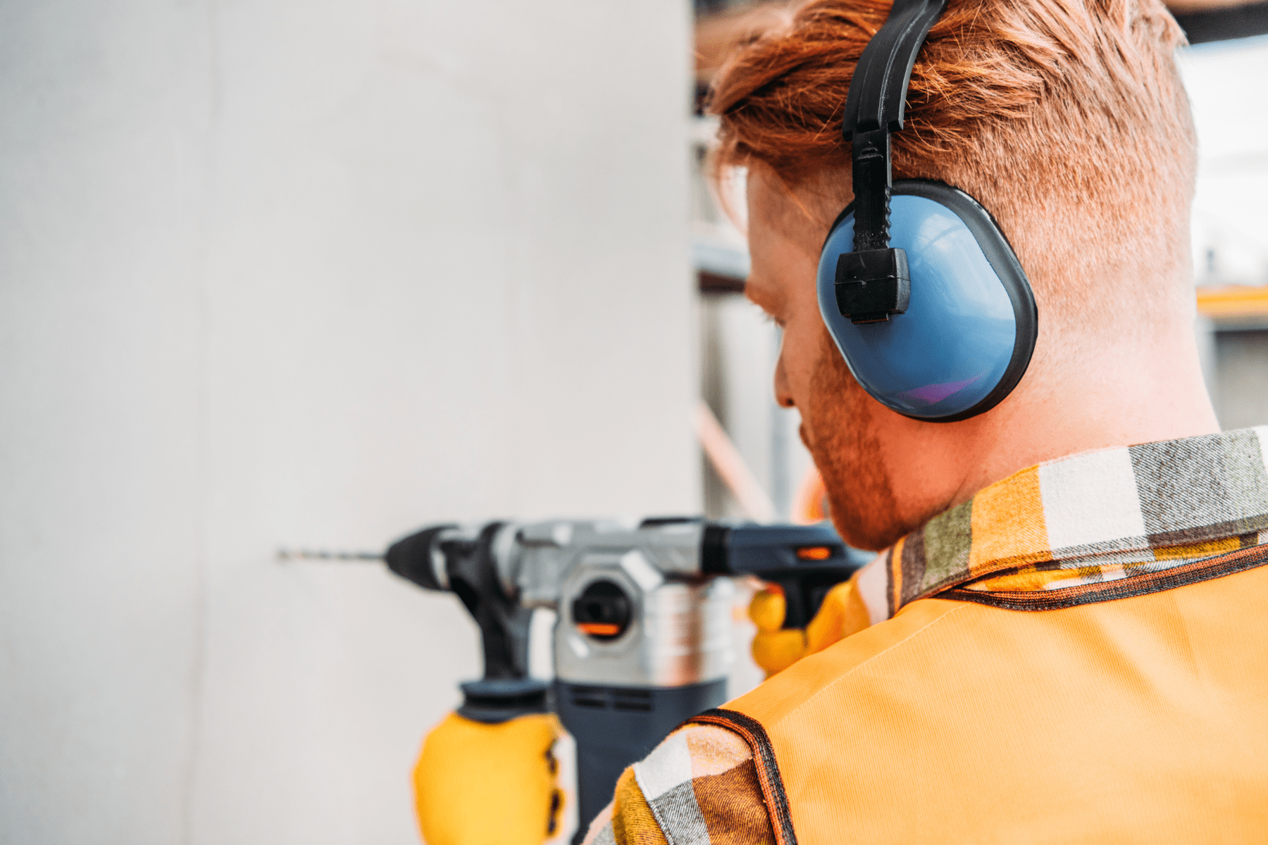 Ouvriers travaillant sur un chantier avec des outils bruyants, générant des nuisances sonores en milieu urbain